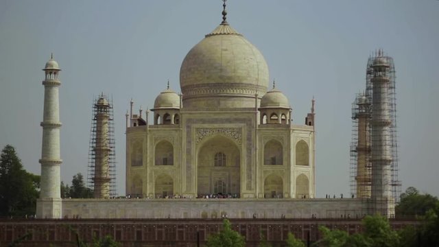 View of the iconic Taj Mahal with three of the four minarets surrounded by scaffolding as they cleanse the marble towers.