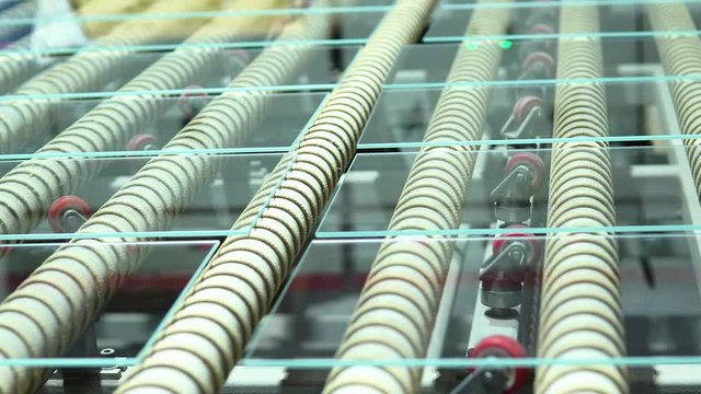 Clip of a glass manufacturing industry manufacturing and processing of ESG glasses. Close up.