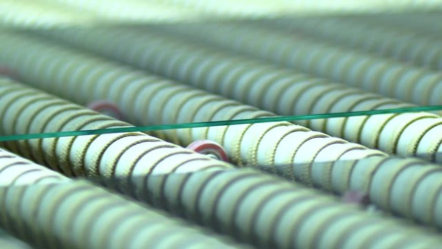 Clip of a glass manufacturing industry manufacturing and processing of ESG glasses. Close up.
