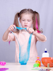 Play with a kid while staying at home quarantine, make slime by yourself. Toy Slime in a kids hand....