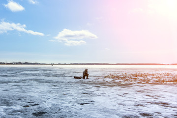 fisherman on a winter fishing trip sits on the lake. fishing, winter sports travel