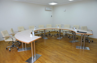 Conference room with a table, chairs and bottles with water set
