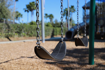 Empty swing in deserted children’s playground