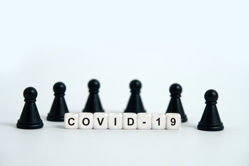 Pandemic coronavirus conceptual photography – stop spreading of COVID19 - word beads surrounded by chess pieces