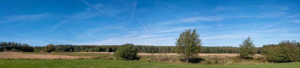 Fototapeta premium A panoramic view over fields and meadows 