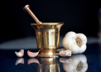 mortar and pestle with garlic and spices
