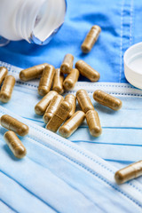 Pharmaceutical medicine tablets, pills, capsules and medical mask on blue background. Medicine concept. Coronavirus