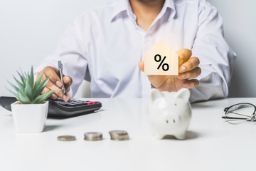 Closeup image of young man hand press on calculator to check and summary expense of home loan...