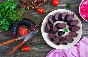 Morsilla - blood sausage. Pieces of Spanish black pudding on a plate. Easter menu.