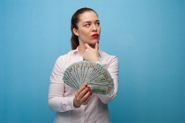 Cute dreamy beautiful woman with banknotes