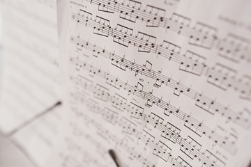 Fragment of sheet with musical notes closeup (very shallow depth of field)