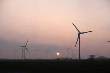 Windturbinen an der Nordseeküste bei Sonnenuntergang