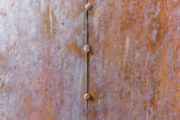 rust on the metal sheet with the remnants of blue paint. Rusty abstract texture. Rust through the paint.