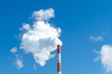 pipe of white smoke, three in a row in the blue sky. emission of steam and smoke into the...