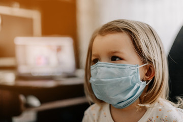 Coronavirus Covid-19 and Air pollution concept. Little caucasian girl wearing mask for protect pm2.5 at home. Covid-19 coronavirus and epidemic virus symptoms.