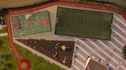 Outdoor football, basketball courts. Children's playgrounds. A bird's eye view of the sports ground. © Vahit Telli