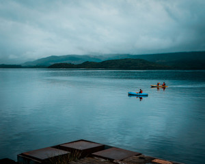 Two Kayaks on a peaceful serene lake in Luss, Scotland. overcast, cloudy day with calm water. Recreational activities. 