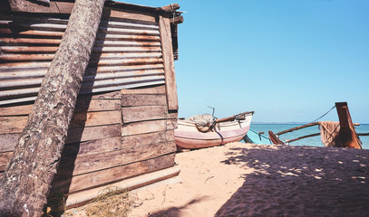 Retro toned picture of an old fishing shack by a beach.