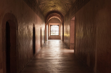 Fototapeta na wymiar Corridor with window at the end of the cloister in Actopan Mexic