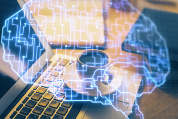 Double exposure of work space with computer and human brain drawing hologram. Brainstorm concept.