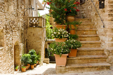 Medieval street of Spello with staircase decorated with flowers