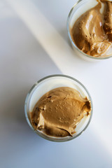 South Korean coffee dalgona – trendy cold latte or cappuccino with milk and cane sugar. Summer drink for breakfast, top view