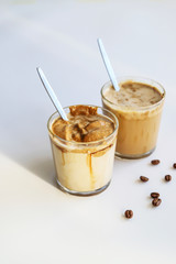 South Korean coffee dalgona – trendy cold latte or cappuccino with milk and cane sugar. Summer drink for breakfast