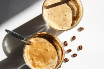 Cold coffee – latte, cappuccino or dalgona. Summer trendy drink with whipped milk, top view