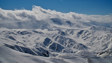 Erzurum Palandoken (Palandöken) mountains and cloudy sky. Palandoken ski resort. Snowy mountain ranges.