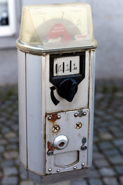 Vintage parking meter on a cobblestone street background. Close-up.
