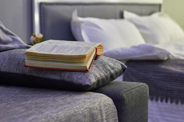 bedroom, the cosiness of an open book lying on the sofa