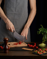 Chef man hands on cook  appetizer sandwiches with guacamole and tomatoes. healthy breakfast food, vegetarian food, diet. Gark style photo.