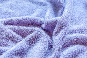 Fototapeta na wymiar abstract background of bright purple terry towel close up