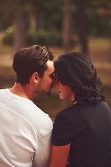 Naklejka premium Couple in love hugging and kissing outdoors. Love concept.