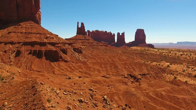 Monument Valley red rock desert Utah Arizona. Monument Valley Arizona Utah drone flying around Red rock climbing buttes towers desert southwest west hot dry sky Navajo nation reservation, plateau mesa
