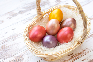 Easter eggs. colored eggs in a basket on Easter holiday. on a light background, wooden background.