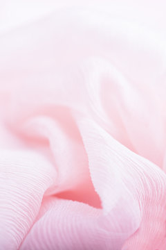 Pale pink corrugated flowing silk fabric background