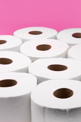 Toilet paper rolls on pink background