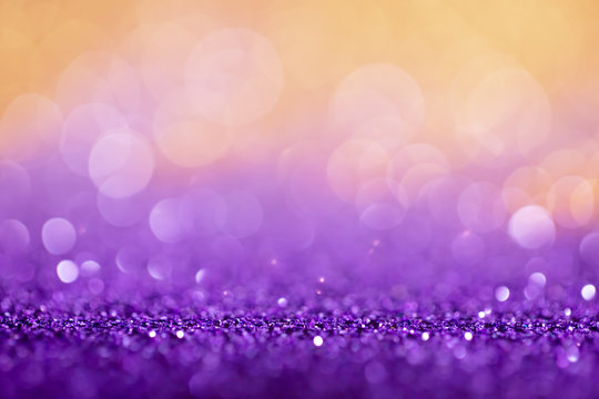 Decoration twinkle lights background, abstract shiny backdrop with circles,modern design overlay with sparkling glimmers. Purple and golden backdrop glittering sparks with glow effect