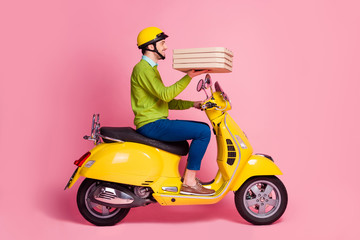 Fototapeta na wymiar Profile side view portrait of his he nice attractive confident glad cheerful cheery guy driving moped bringing dessert baked pie call house isolated over pink pastel color background