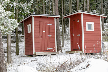 Public toilet. Red toilet booth in a public place.