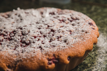 Delicious homemade baked fruit pie with powdered sugar.