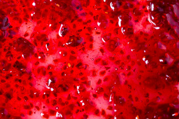 Red raspberries jam textured background, copy space