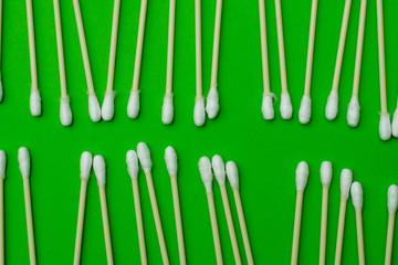 ear buds laid out on a green background. business concept. close-up