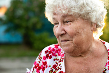 Senior happy woman smiling in garden