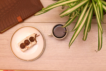 cack, notebook, plant on wooden table