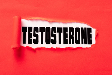 Testosterone lettering on white surface in hole of red paper