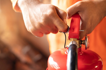 hand Pull latch presses the trigger fire extinguisher available in fire emergencies conflagration...