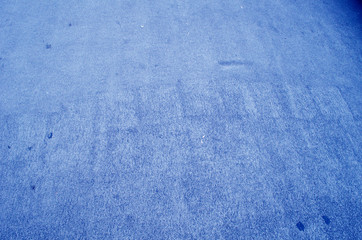 Blue background. Wall covered with old cracked stucco, tinted in classic blue. Bright neon backdrop. Modern urban industrial concept. Copy space. Selective focus image.