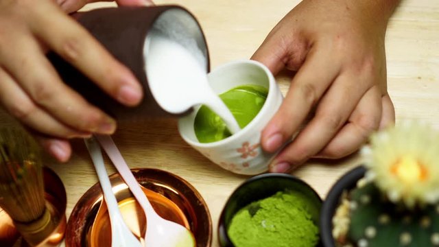 Matcha Latte Tea, Barista crafts a colorful matcha latte in coffee shop.